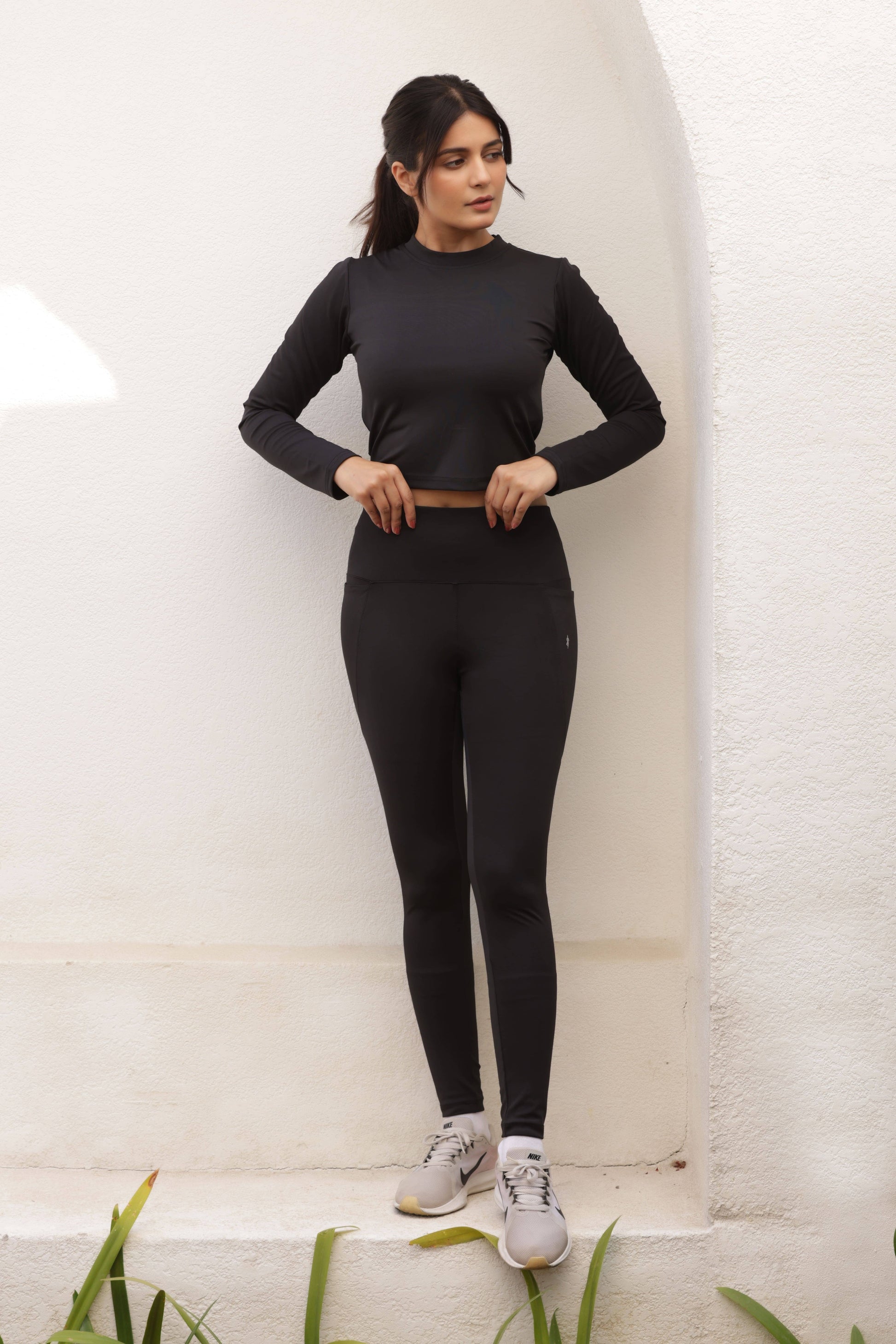 TAAPAZ Georgina Black Co-Ord Set for women, featuring high-waisted tummy-control jeggings and a full sleeve crop top. Seamless, moisture-wicking, and stretchable activewear set for gym, yoga, running, and everyday athleisure wear