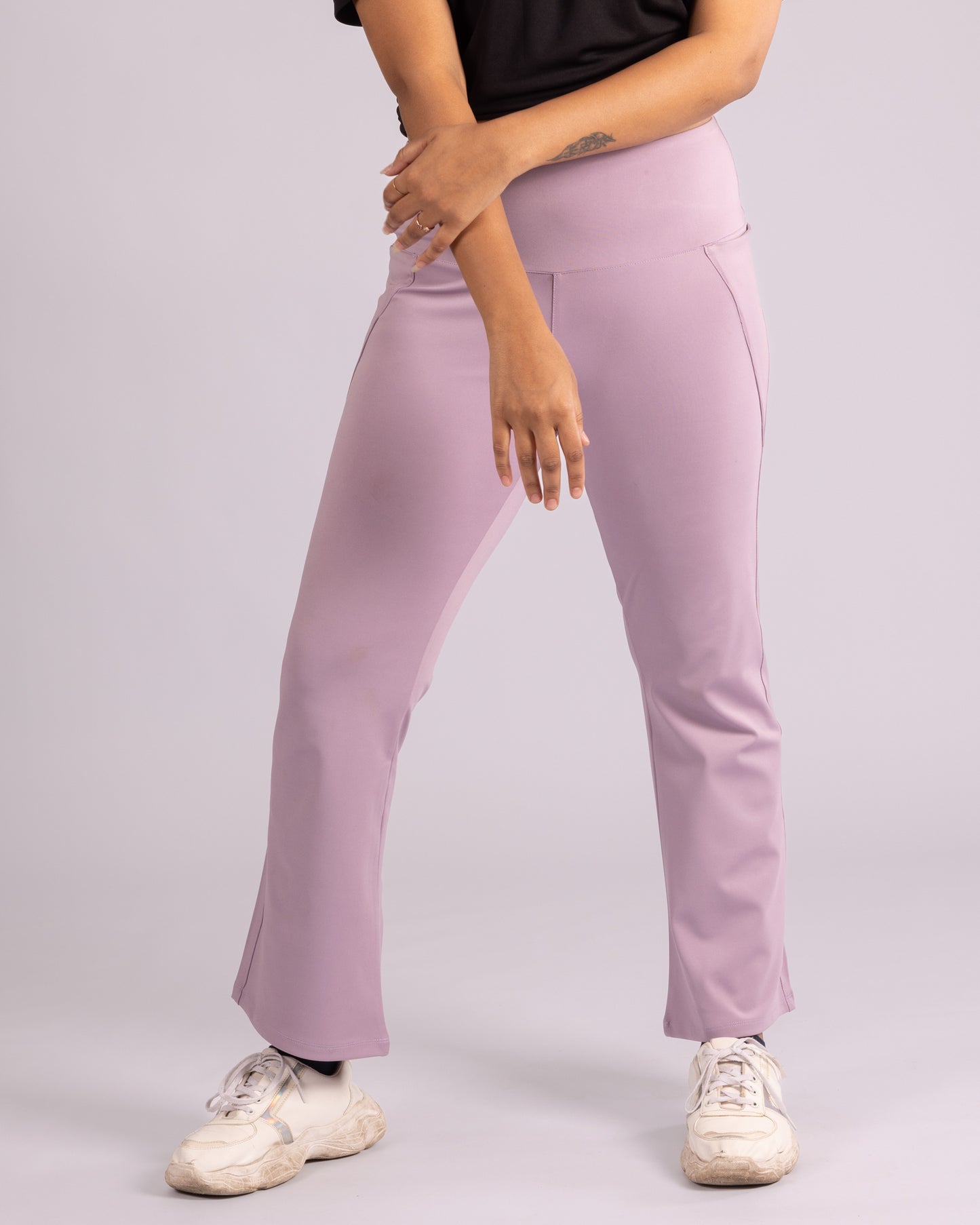 High-waisted lavender flared trousers for women, designed with a flattering silhouette, superior stretch, and ultra-soft Lycra fabric for all-day comfort. Sweat-wicking and breathable for intense workouts, yoga, running, and athleisure wear. Trendy, stylish, and functional gym leggings with flare-bottom styling for a fashionable sporty look