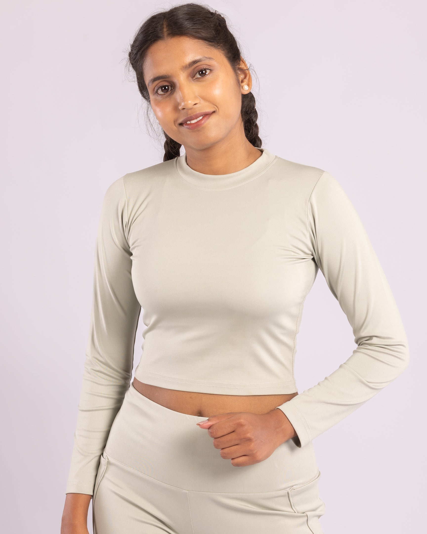 Women's sage green co-ord set with high-waisted flared trousers and a fitted full-sleeve crop top. Made with moisture-wicking, stretchable Lycra fabric for gym workouts, yoga, Pilates, running, and casual wear