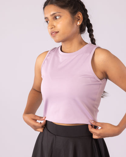 Lavender sleeveless crop top for women, designed for a snug, form-fitting look with flexible Lycra material for maximum stretch and movement. Ideal for gym workouts, yoga, running, and activewear. Moisture-wicking, lightweight, and breathable fabric enhances comfort while providing a chic, athletic aesthetic for daily athleisure wear