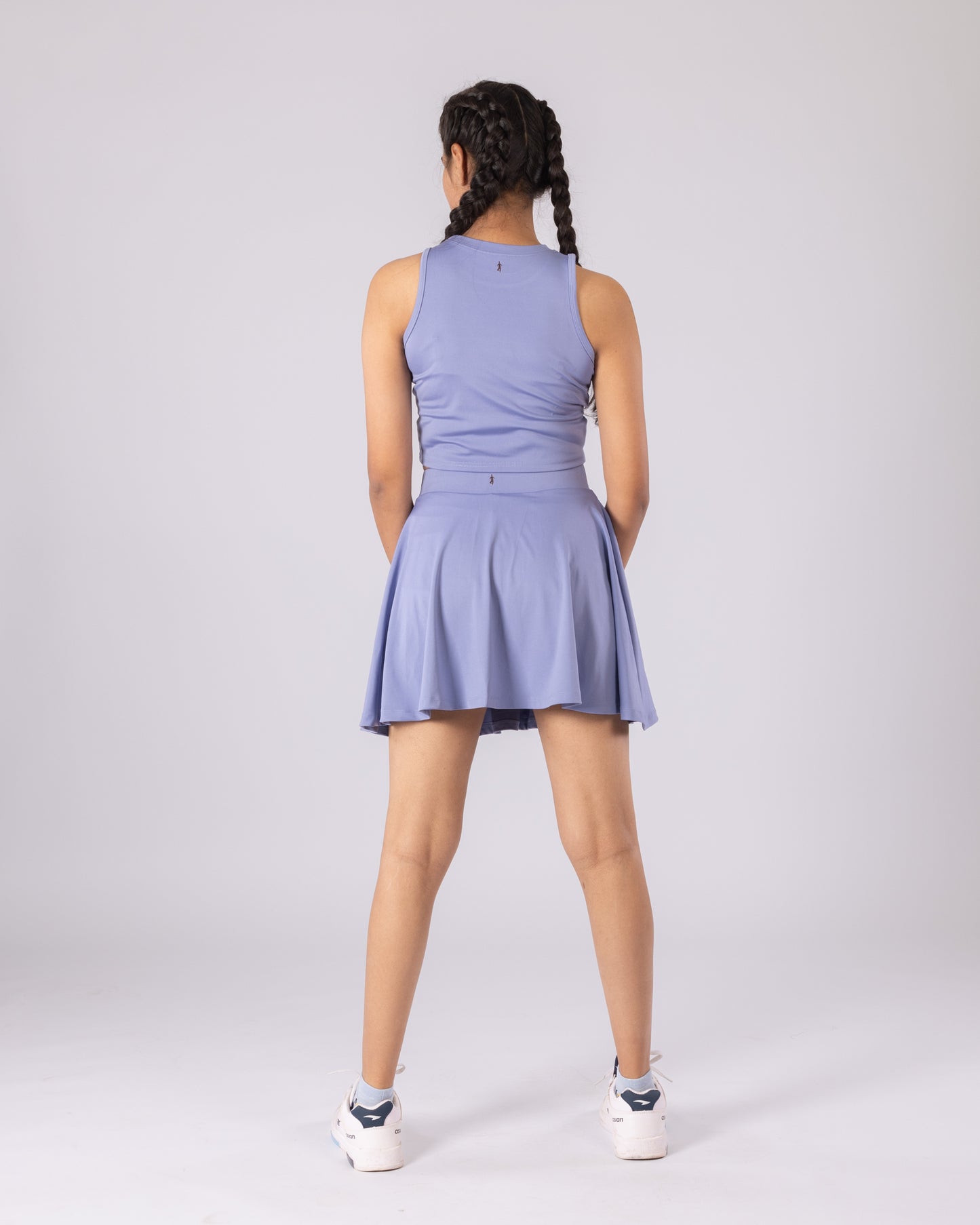 Back view of the lavender tennis skort, highlighting the high-rise waistband, sculpted fit, and smooth, stretchy Lycra fabric that moves with your body for high-impact activities like running, tennis, and training.