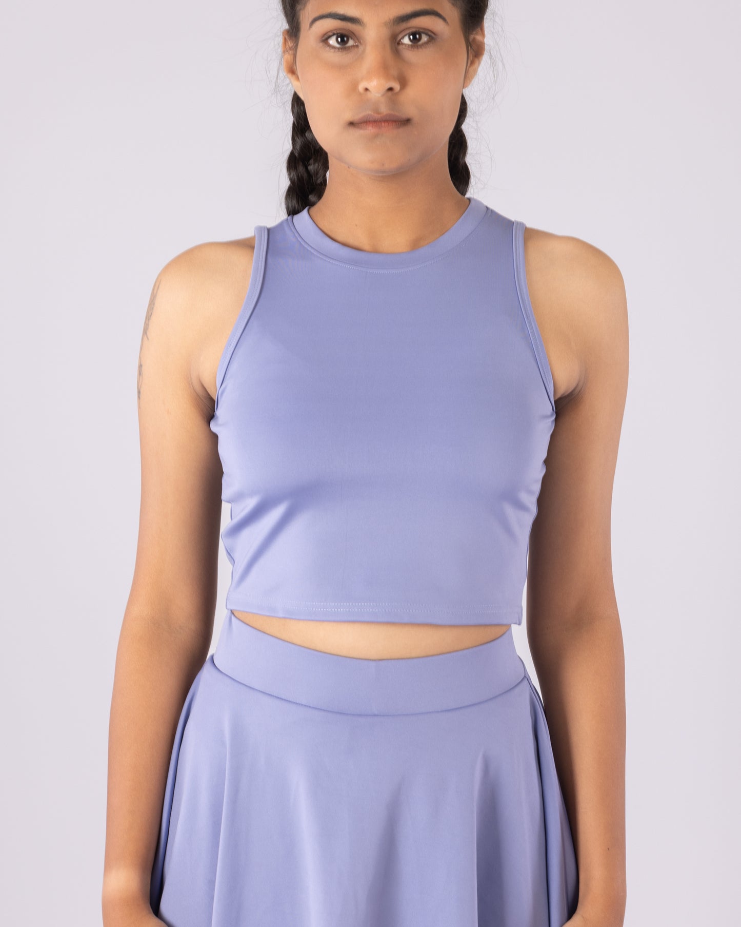 Powder blue sleeveless crop top made from premium Lycra, offering a snug yet flexible fit. Designed with moisture-wicking technology, this top provides comfort, breathability, and a sleek, form-fitting silhouette—perfect for workouts or casual wear